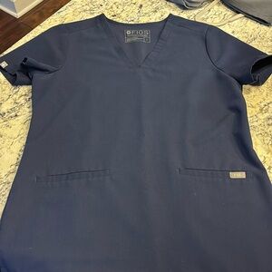 In great used condition. Size small Figs scrub top. Navy blue